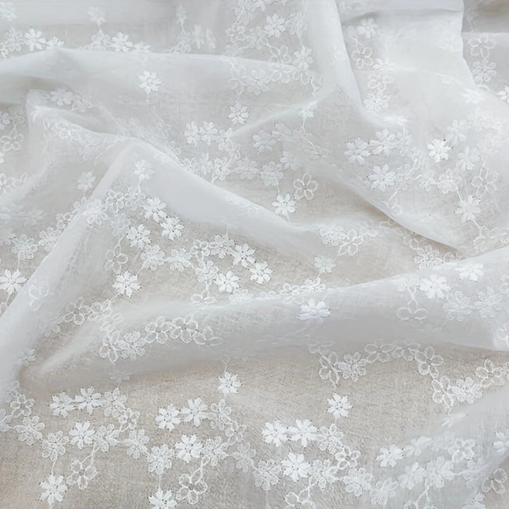 Sheer embroidered cotton fabric with eyelet design