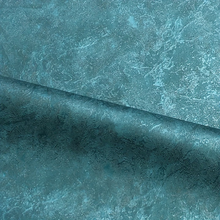 Close-up of dark teal marble effect wallpaper texture