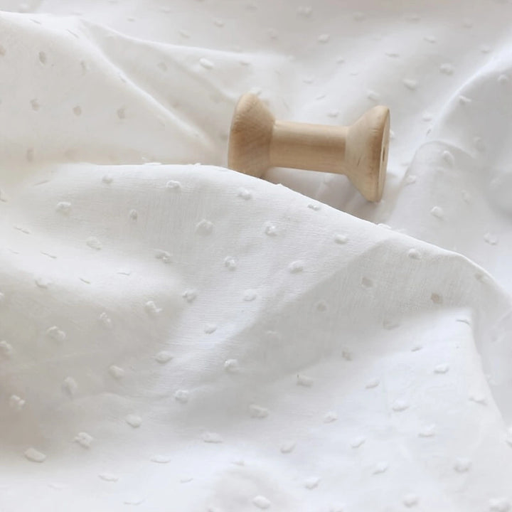 White cotton jacquard fabric with polka dot pattern