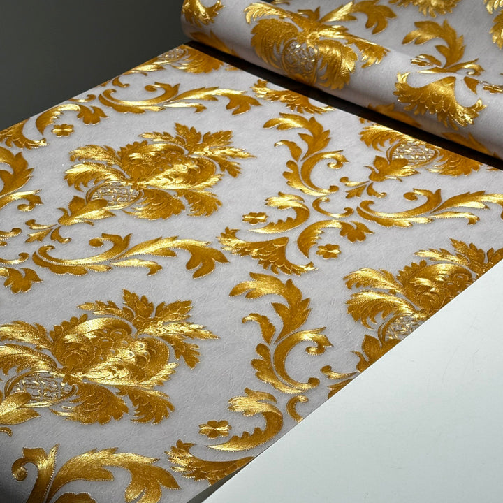 Luxury damask wallpaper in gold tones used as a statement bedroom wall design
