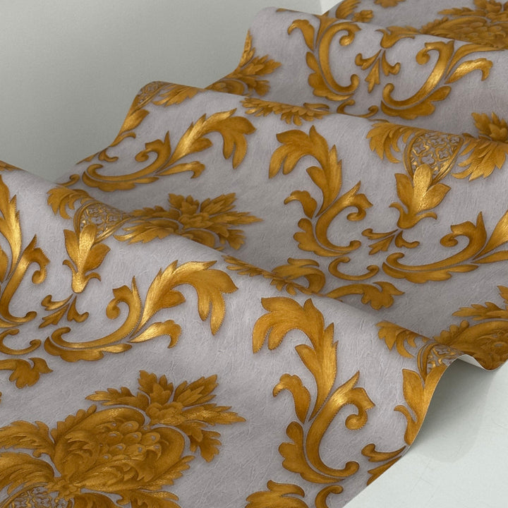 Interior view of a bedroom with gold metallic damask wallpaper accent wall