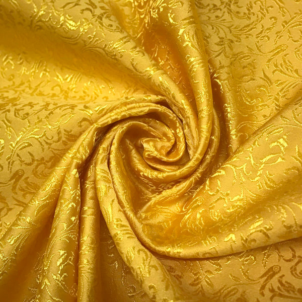 Golden jacquard brocade satin fabric with detailed woven floral design