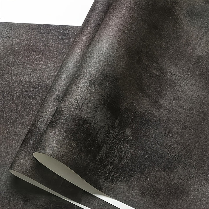Textured black concrete wallpaper on living room wall