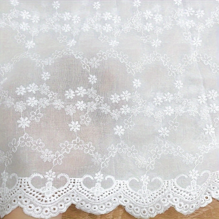 Floral broderie anglaise on cotton voile fabric